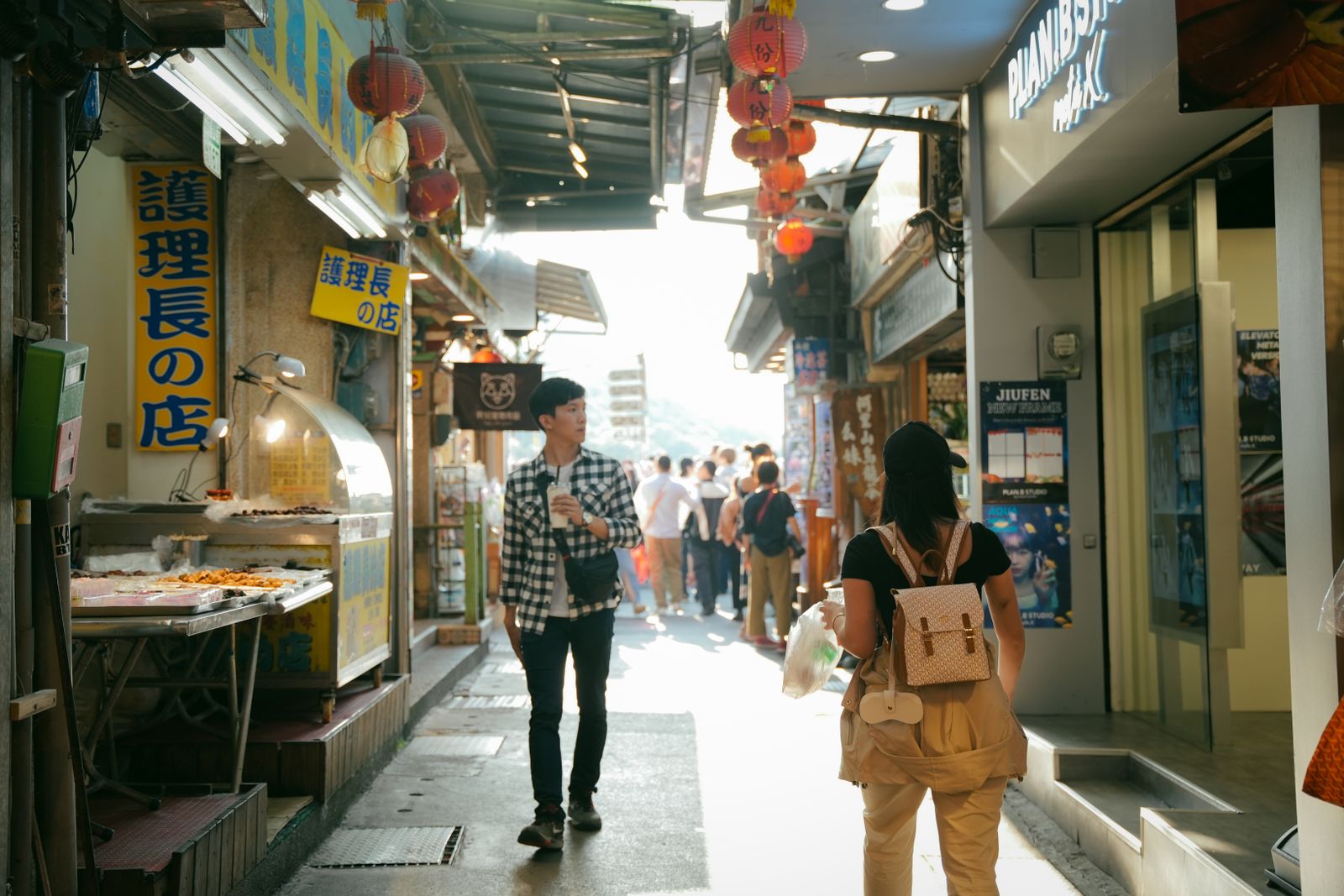 People walking through Jiufen's narrow market street