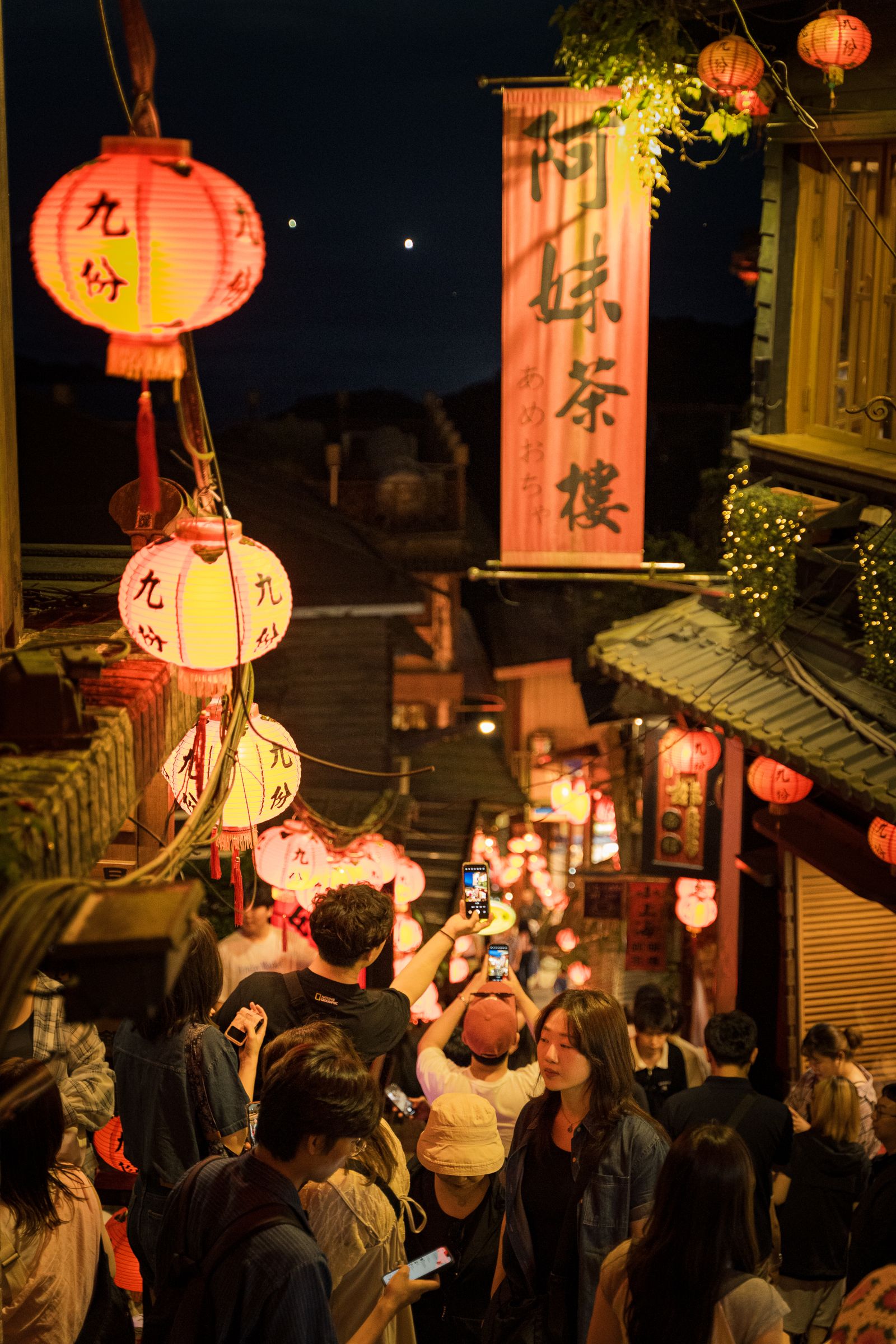 Lanterns glowing above a narrow Jiufen stair street