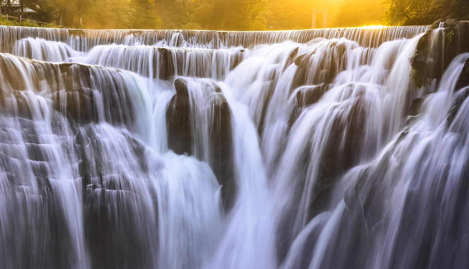 Shifen Waterfall glowing in late golden light