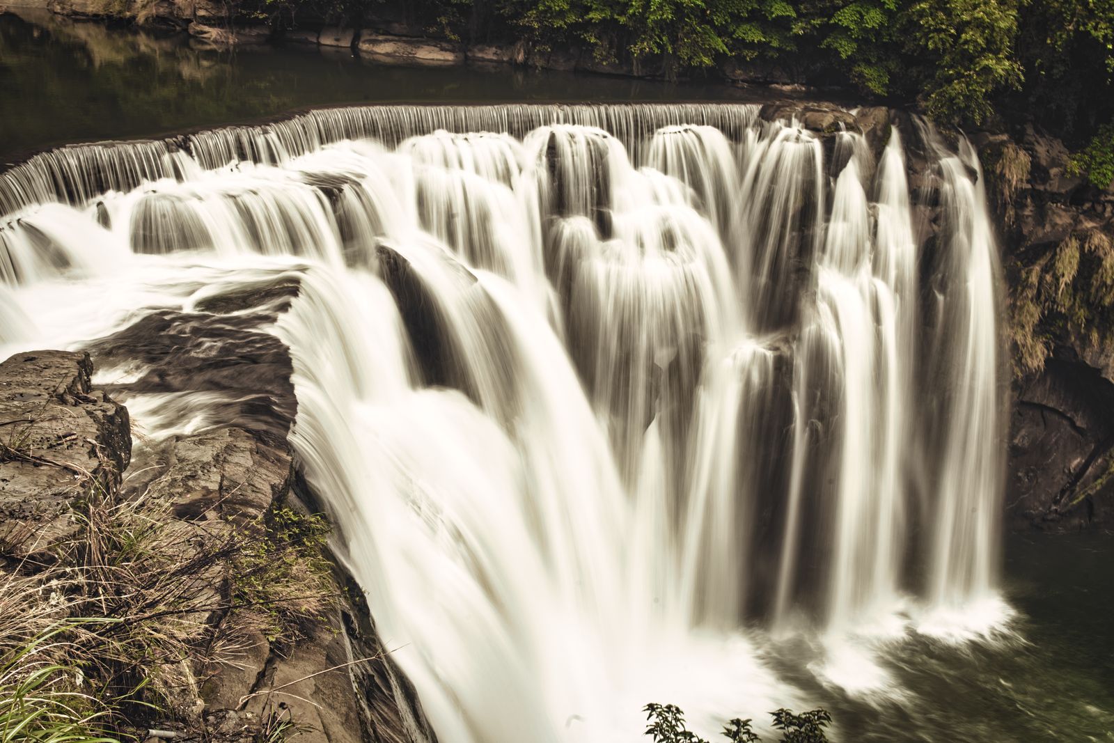 Shifen Waterfall dropping in a wide white curtain